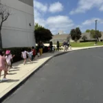 A group of children walking together on a supervised field trip outing from GMCC childcare